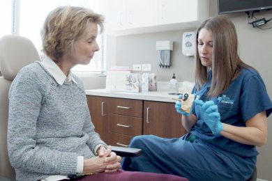 Female ENT physician demonstrating ear treatment using model of an inner ear