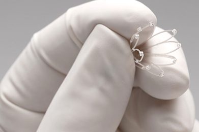 Gloved hand holding the PROPEL sinus implant device